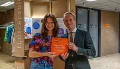 Burgemeester van Grootheest overhandigt het eerste vriendenboekje ‘Vrienden van Oosterhout’ aan Fien. Foto: Casper van Aggelen.